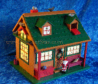 It's a little log cabin, complete with green roof, two gabled windows on top and a front porch. And behind 24 windows and openings are birds of all kinds, to be brought out and perched, one by one, during the countdown to Christmas.